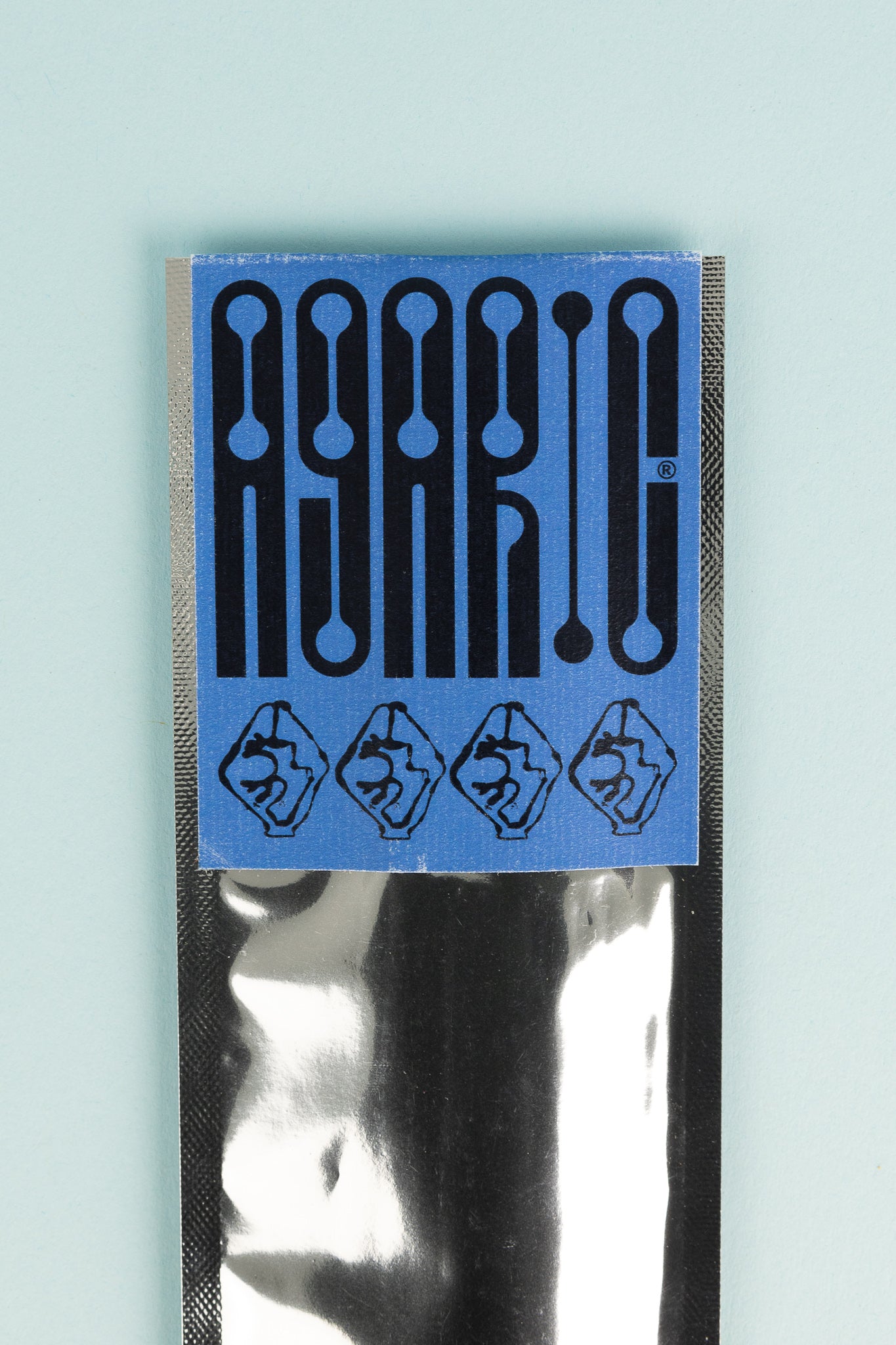 Agaric Fly - Arzach Incense packaging with logo and design elements on a pastel background.