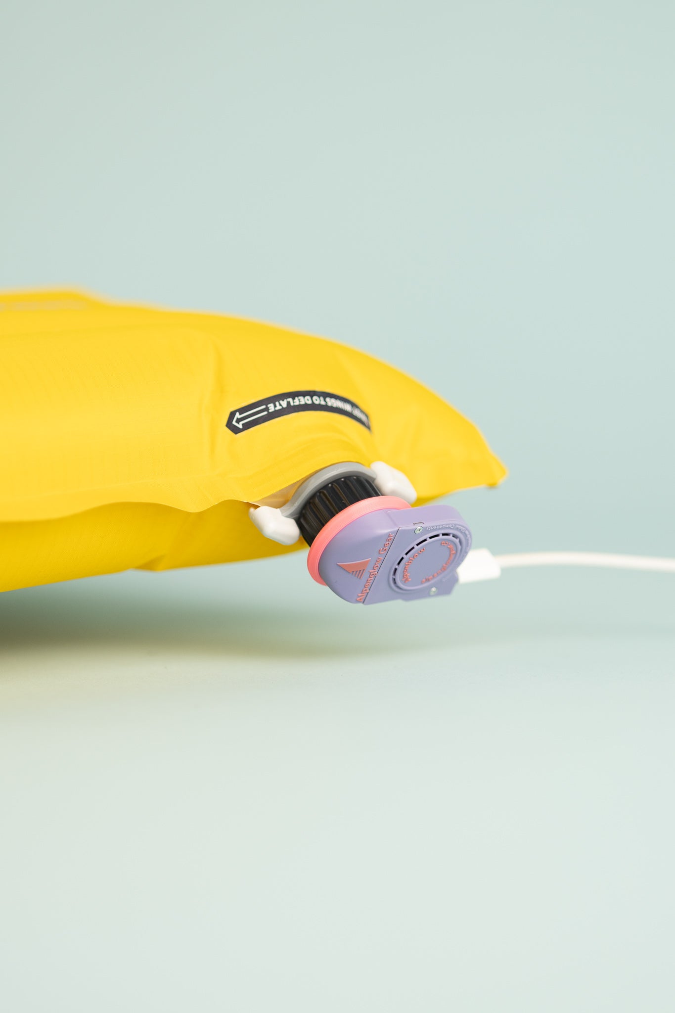 Close-up of the charging port on the Alpenglow Gear Alpenblow Micro Inflator, showcasing its sleek design and compatibility.