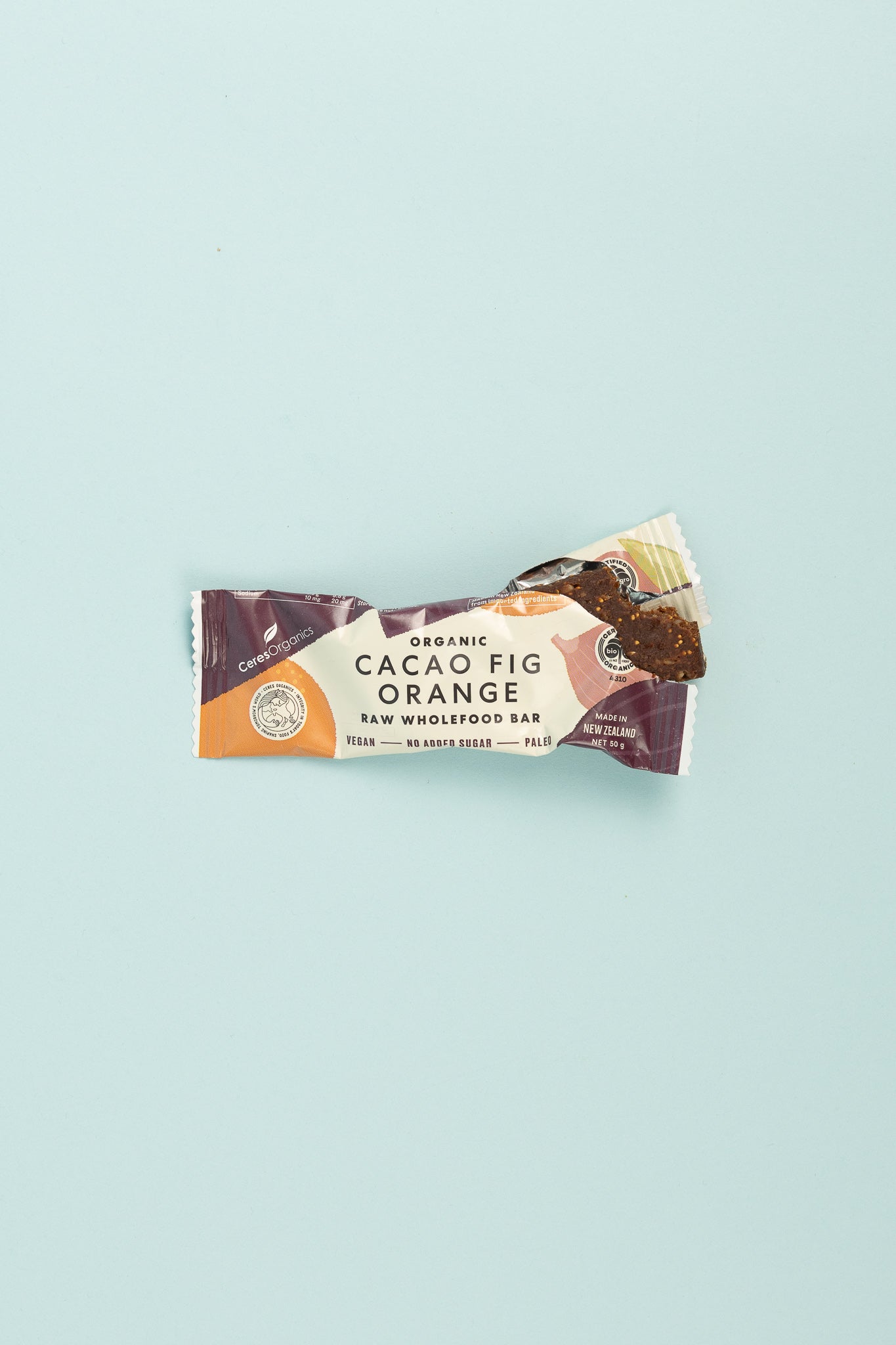 Ceres Organics Raw Wholefood Bar - Cacao Fig Orange packaging on a light blue background