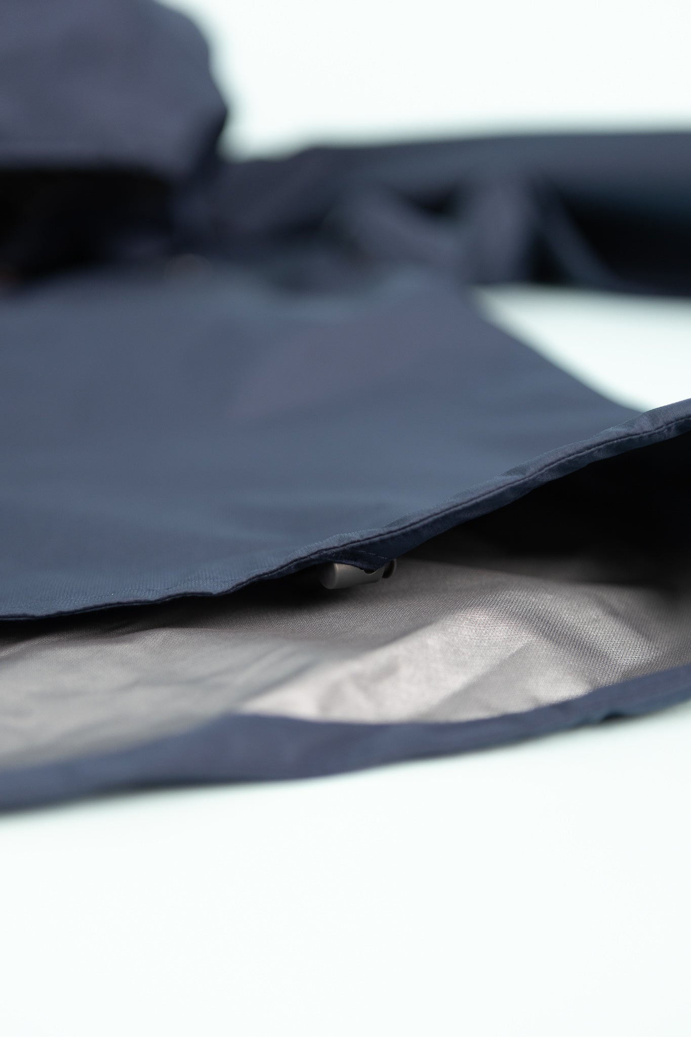 Close-up of the Montbell US Men's Tempest Jacket showing the navy outer layer and inner lining.