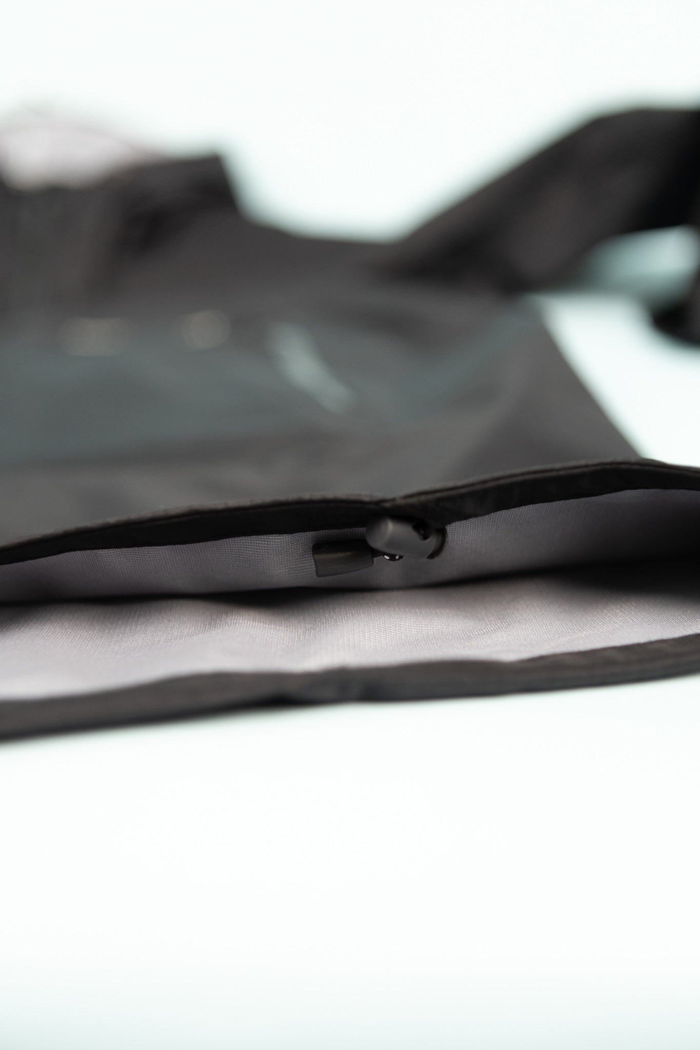 Close-up detail of the Montbell US Men's Rain Trekker in black fabric showcasing the inner pocket.
