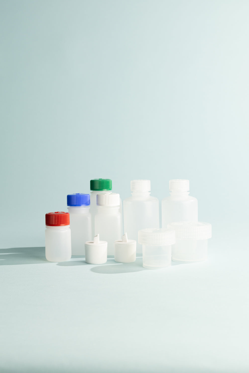 Travel Kit featuring 8 vials in various sizes with colorful lids for travel essentials.