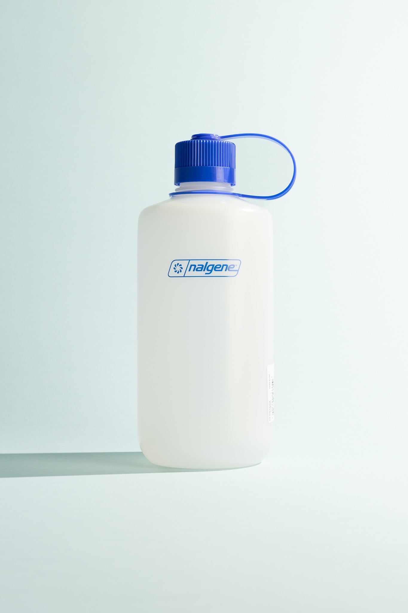 Ultralite N/M 1L water bottle with blue cap, lightweight and durable, ideal for hiking and outdoor activities.
