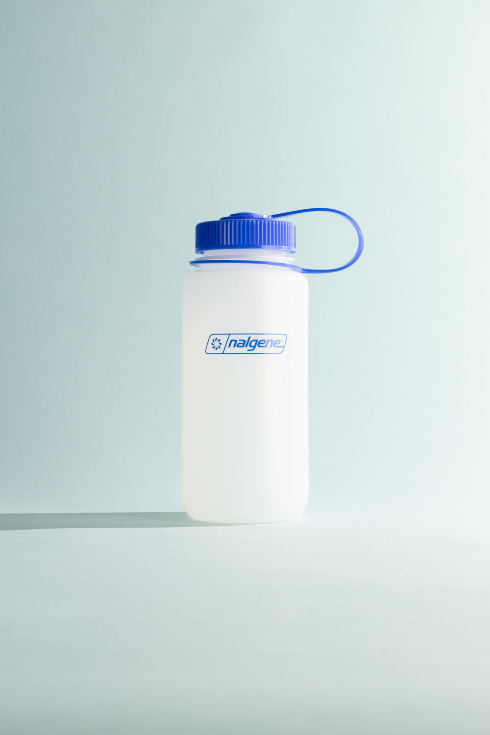 Nalgene Ultralite W/M 500ml water bottle with blue cap against a light background.