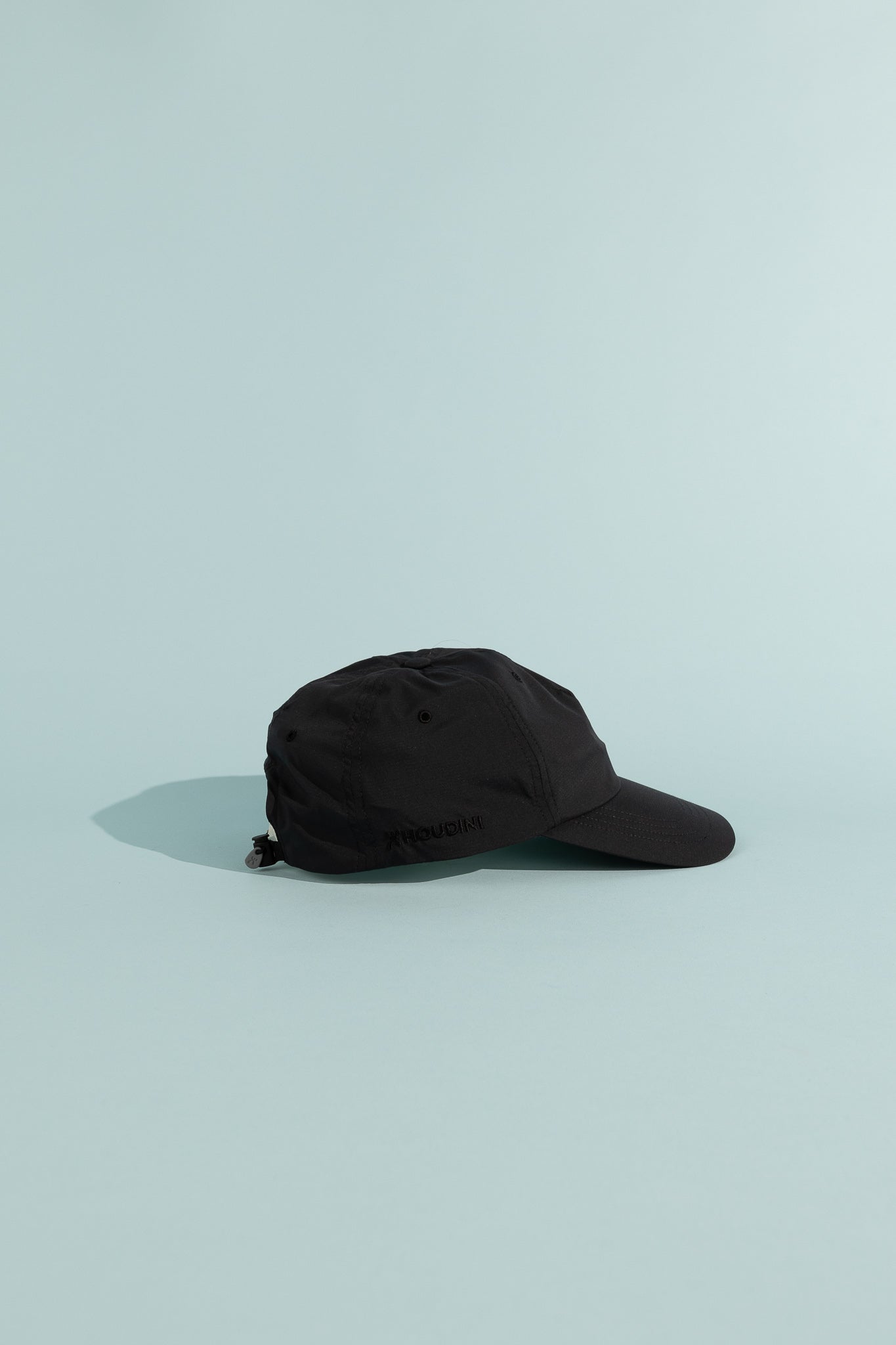 C9 Cap in True Black displayed on a light background, showcasing its lightweight and breathable design.