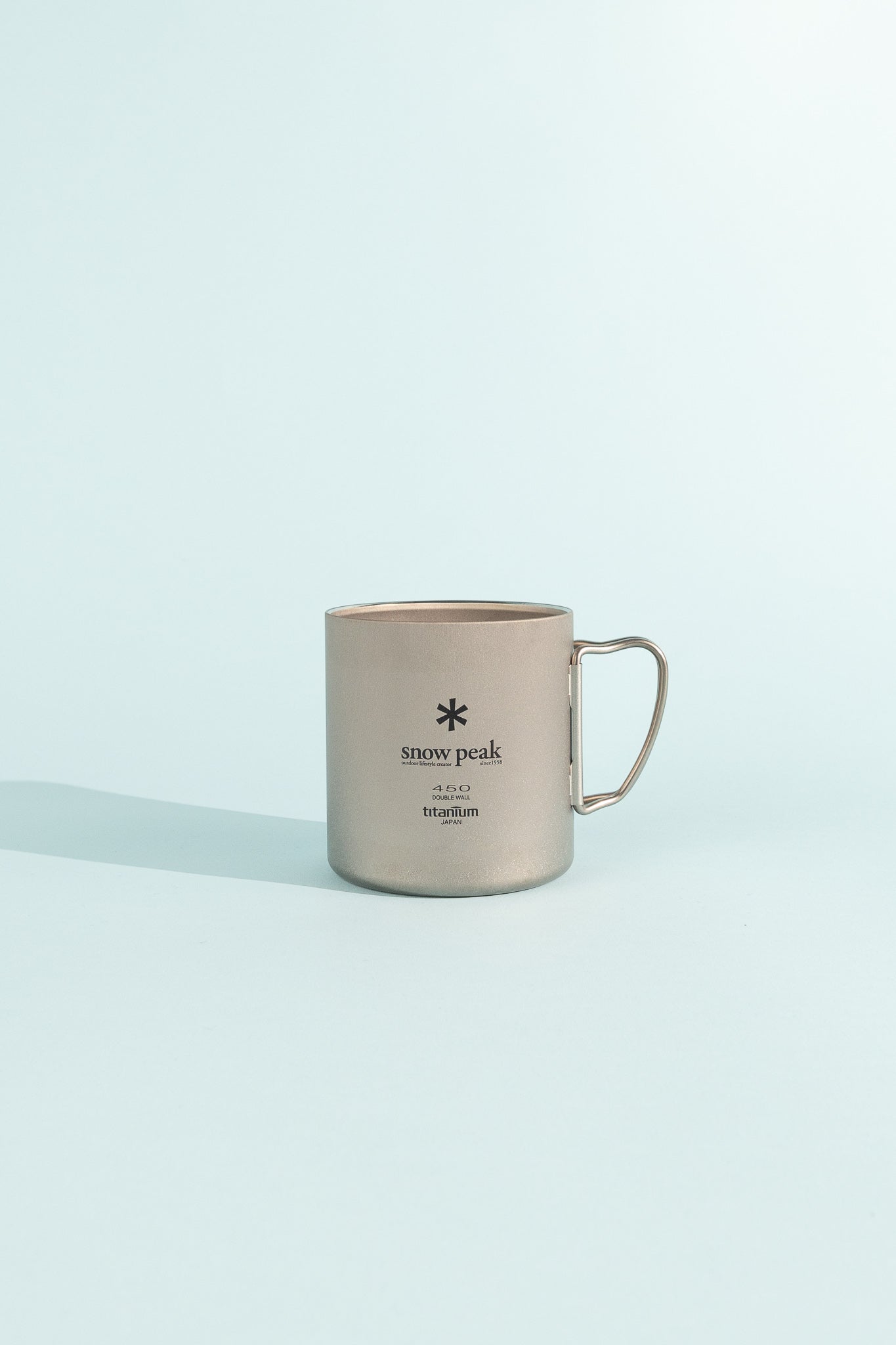 Titanium Double Wall Cup 450 made of durable titanium, perfect for camping adventures.