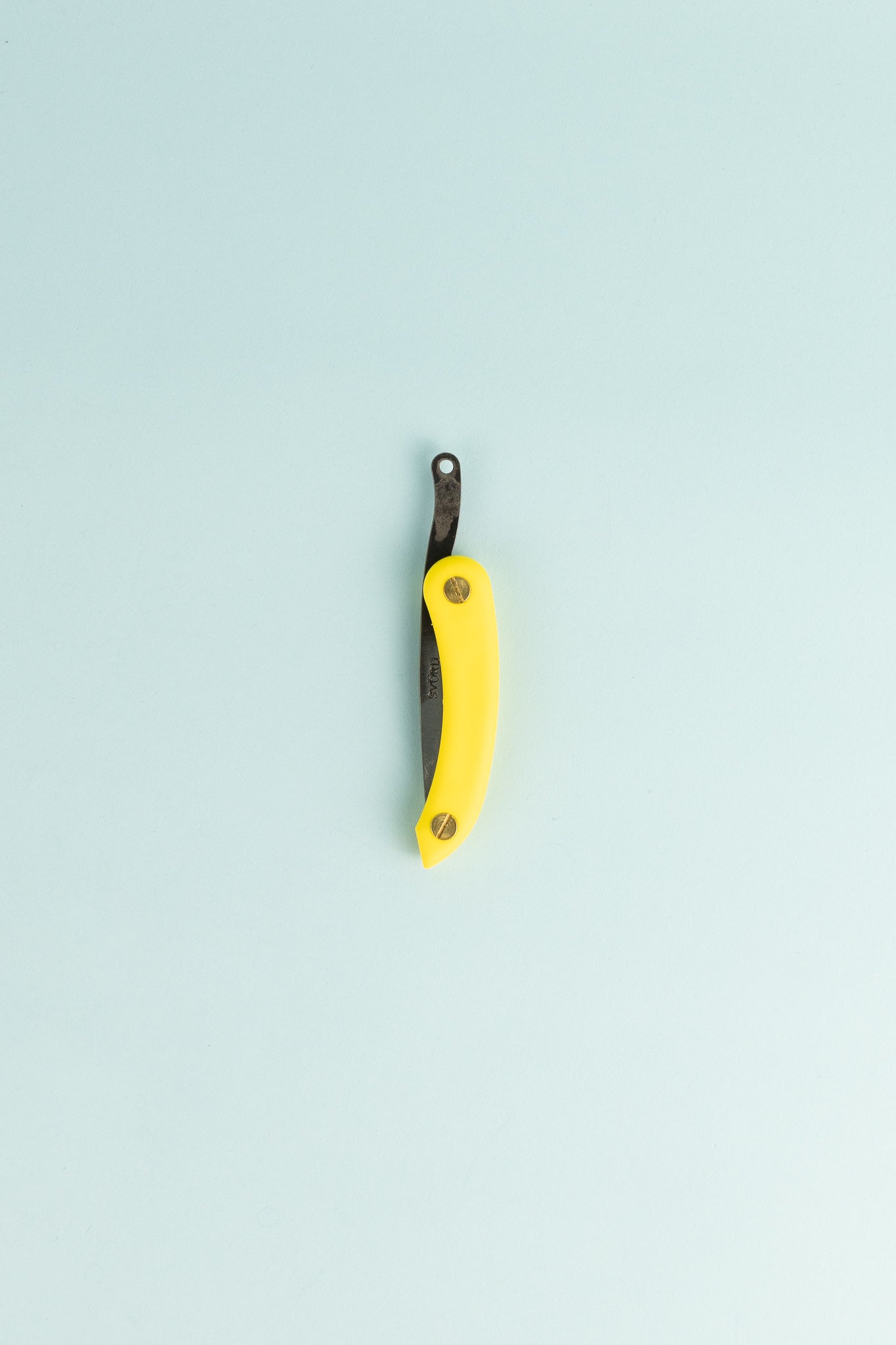 Peasant Knife Mini - Yellow with a sleek design on a light blue background, showcasing its handcrafted features.