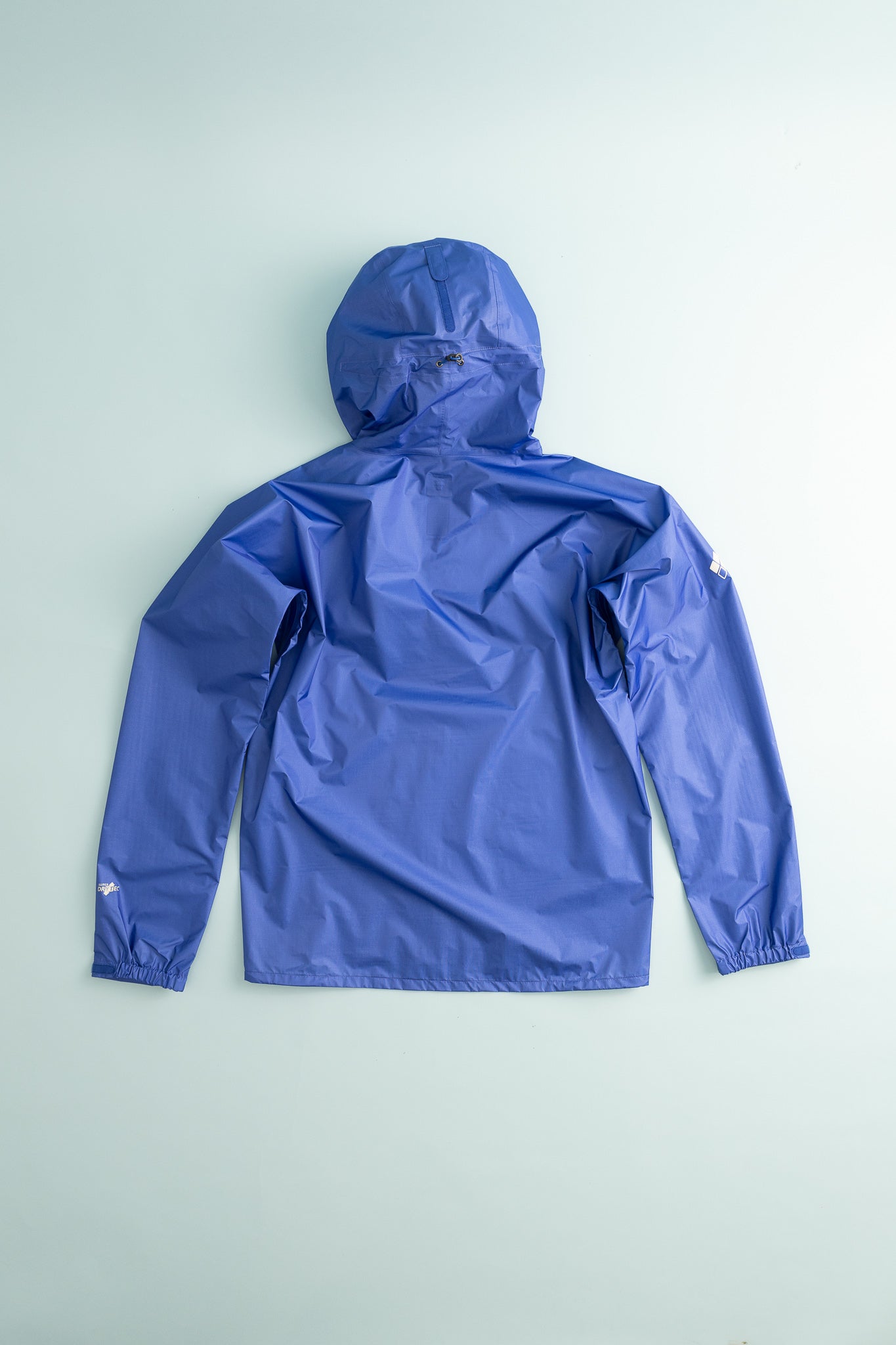 US Men's Versalite Jacket in blue, showcasing the back view and hood detail.