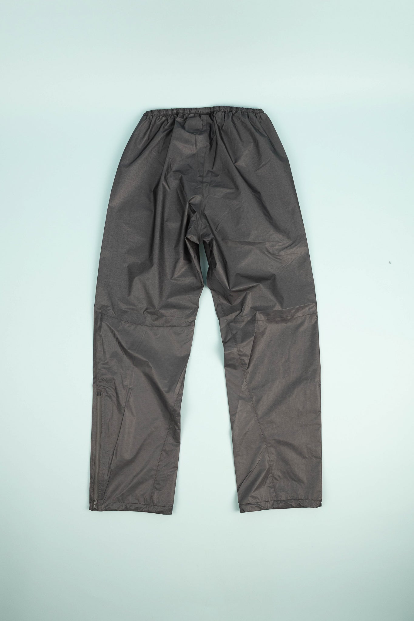 Montbell US Women's Dry-Tec U.L. Rain Pants in dark gray, showcasing ultralight fabric perfect for wet conditions.