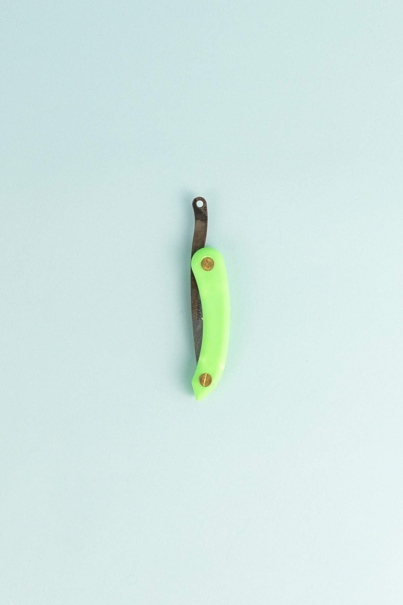Peasant Knife Mini - Green on a light blue background, showcasing its handcrafted design and vibrant handle.