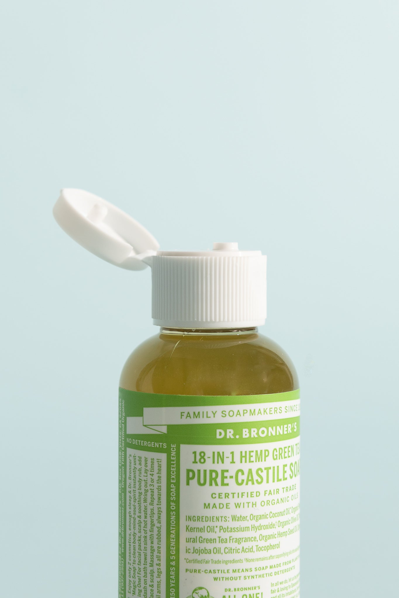 Green Tea Pure-Castile Liquid Soap 59ml bottle with a white cap against a light blue background.