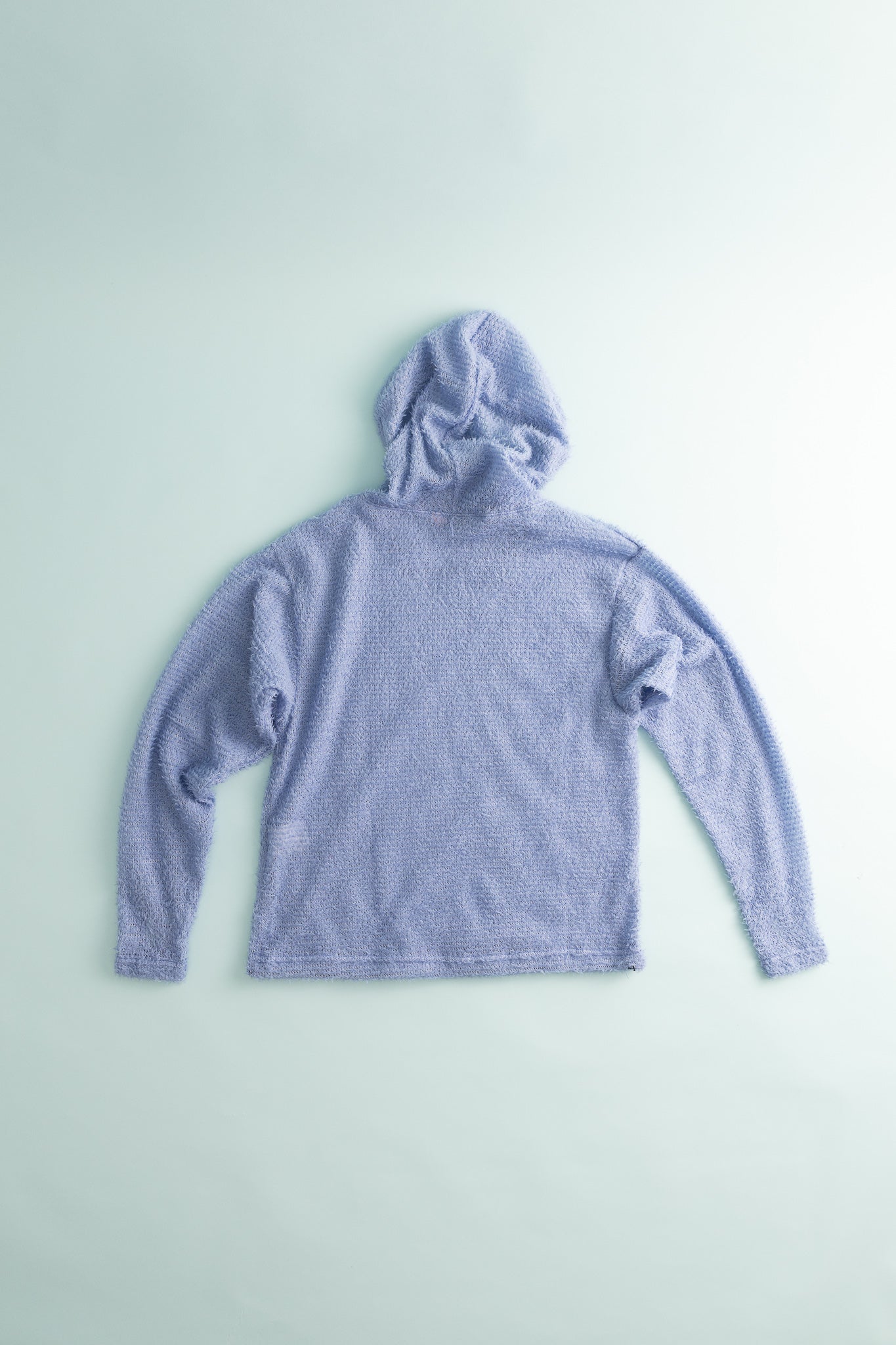 Back view of the Shag Hoodie v2.0 in soft lavender color, showcasing its boxier fit and cozy texture.