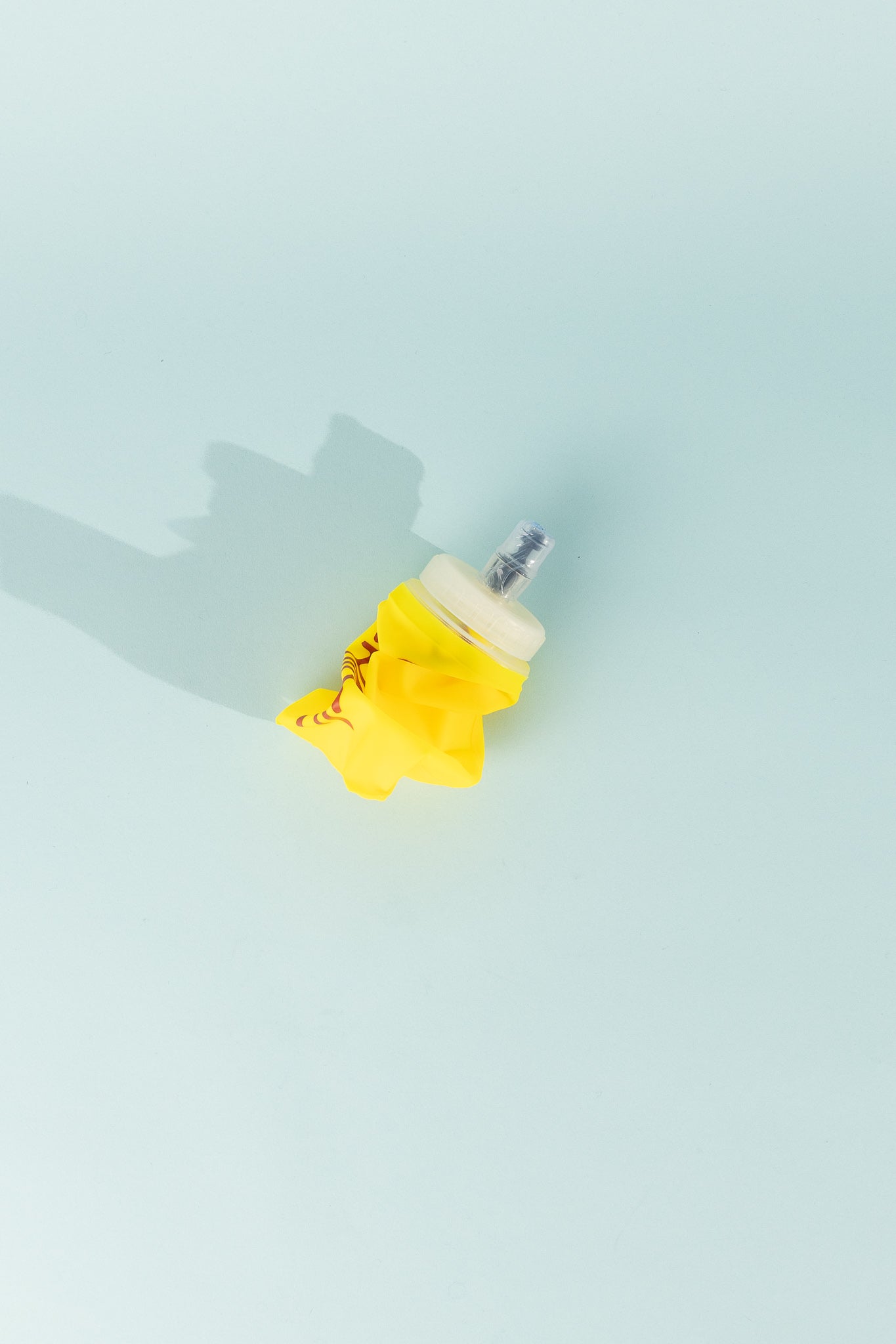 Floppy Water Bottle in yellow color, collapsible and soft, ideal for reusable hydration on the go.