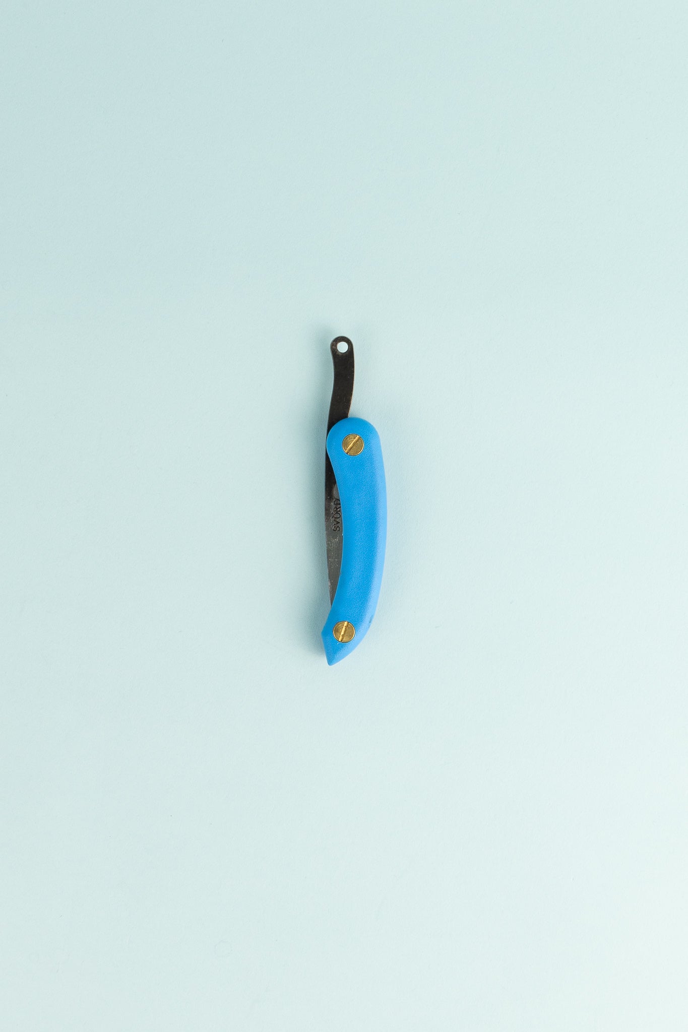 Peasant Knife Mini - Blue laid on a light background showcasing its craftsmanship and unique design features.