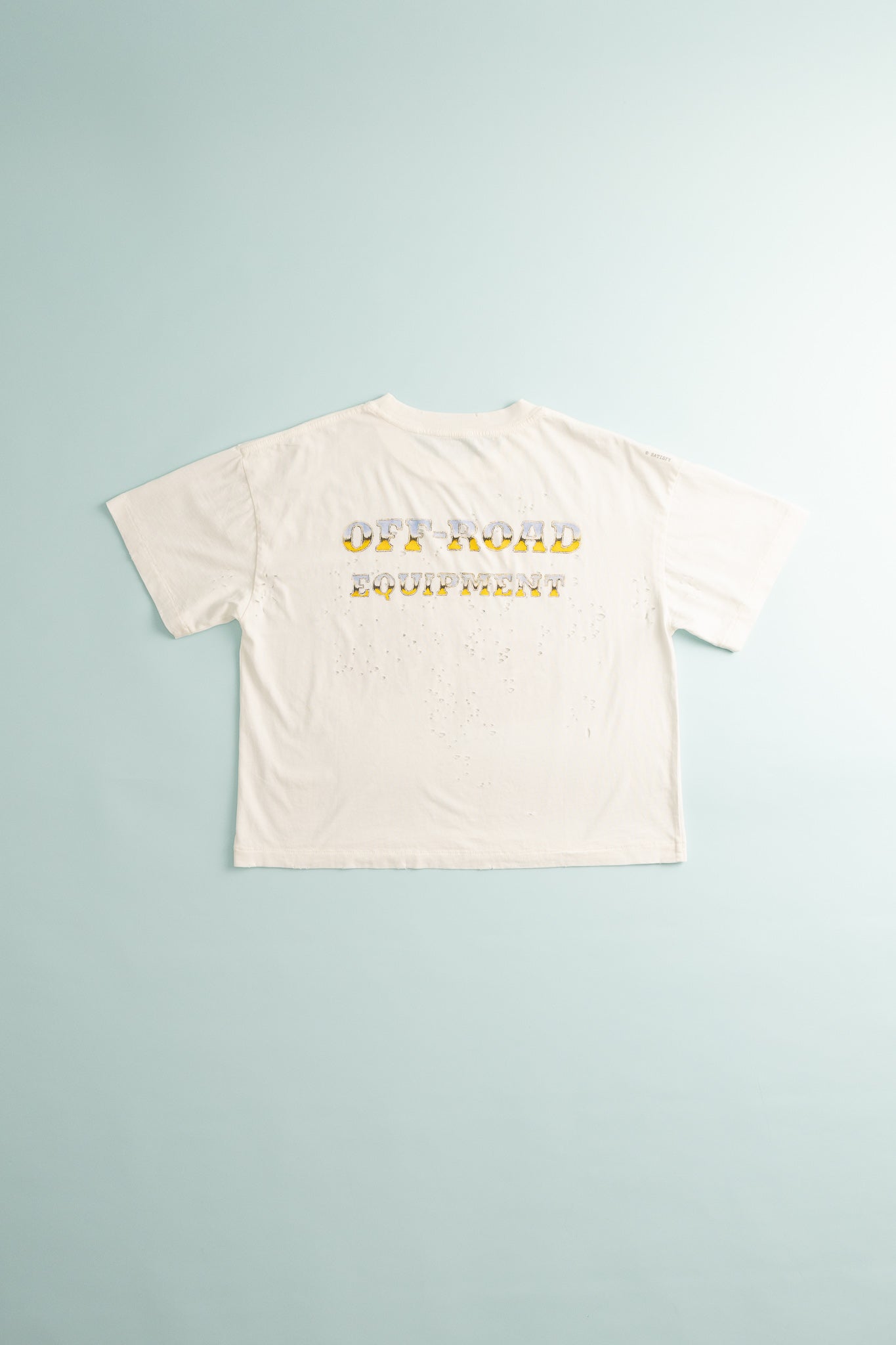 Women's MothTech™ T-Shirt in off-white with monster truck design on the back, showcasing ventilation features.