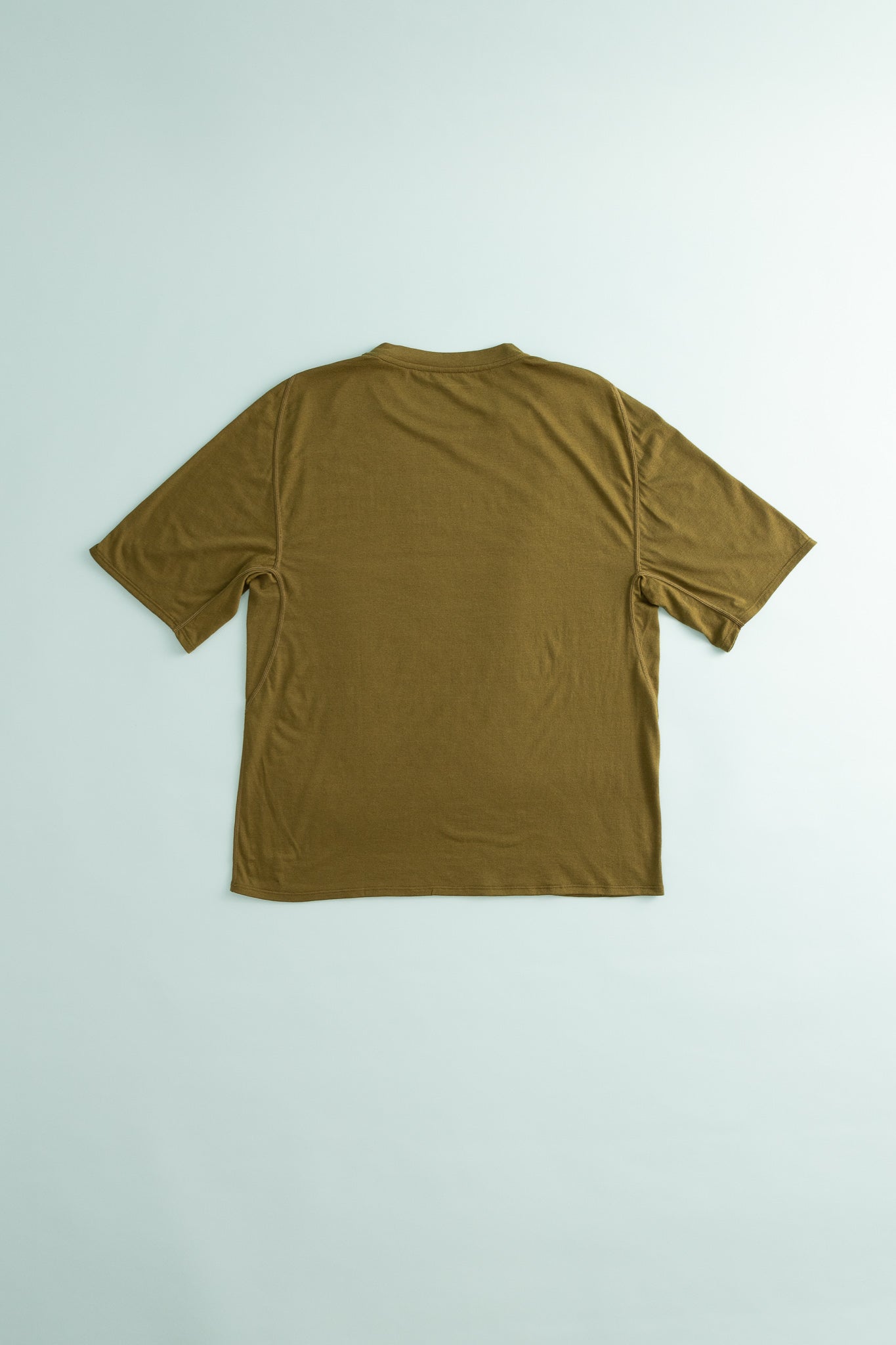 Back view of the Drift Merino Tee in Dark Olive, featuring a soft ergonomic fit and durable merino wool blend.