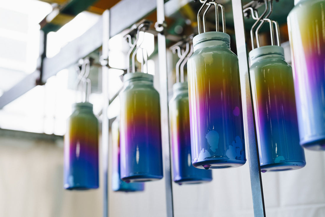 The making of Snow Peak's Titanium Aurora Bottle with colorful gradients on metal bottles.