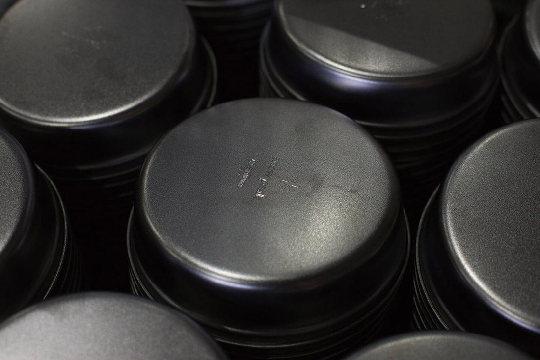 Snow Peak titanium cookware stacked neatly, showcasing high-quality materials for outdoor cooking.