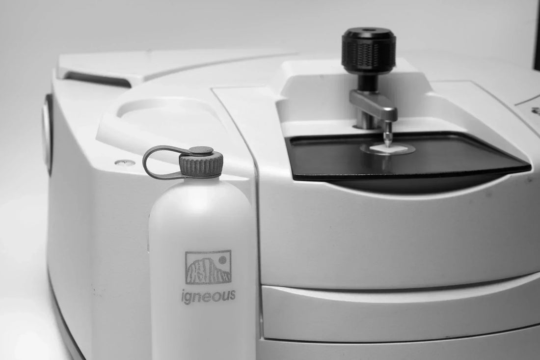 The NOBO bottle next to a scientific instrument during laboratory analysis procedures.