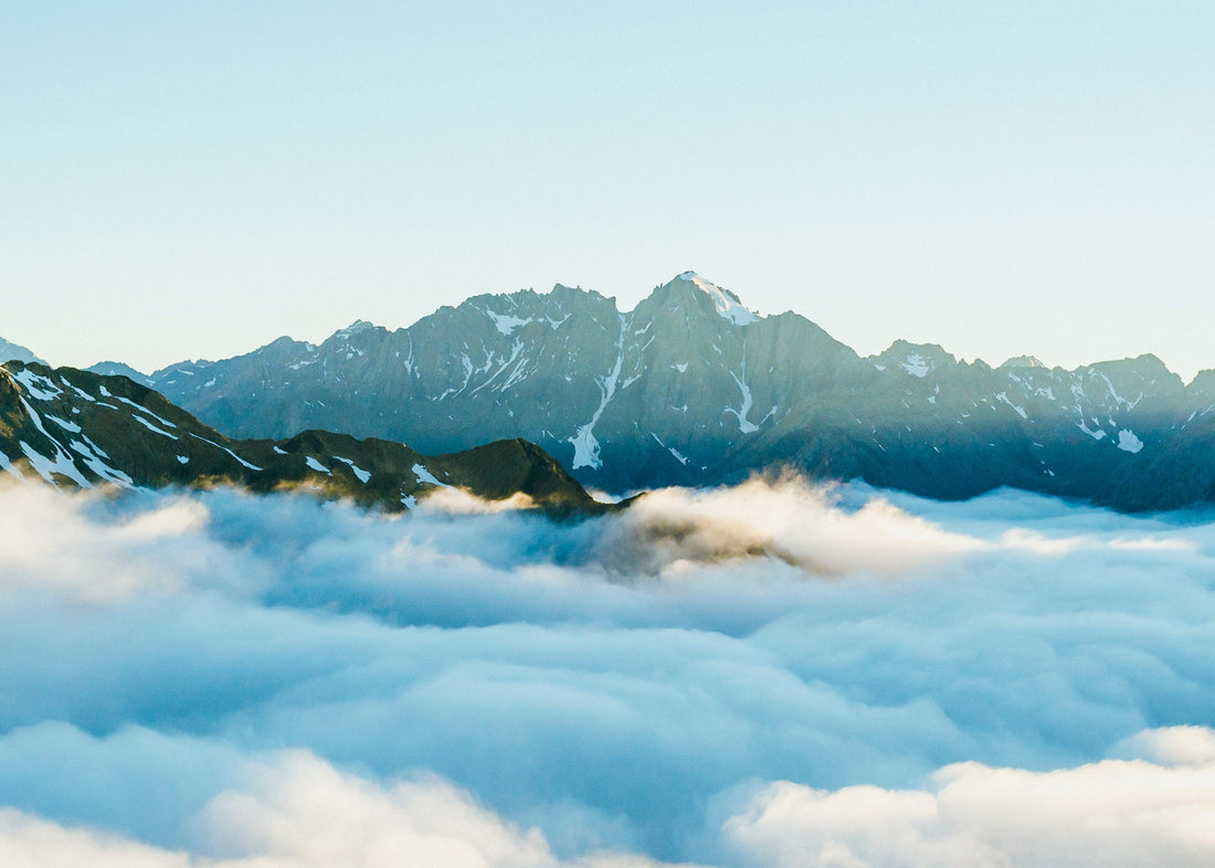 Mountain peaks rising above clouds representing the experience the sublime.