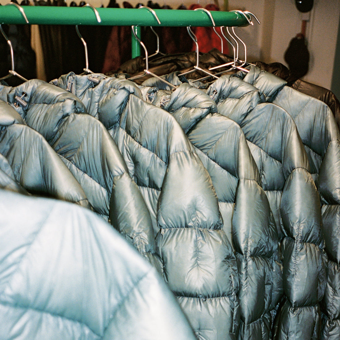 Choosing your Montbell Jacket displayed on hangers in a clothing store.