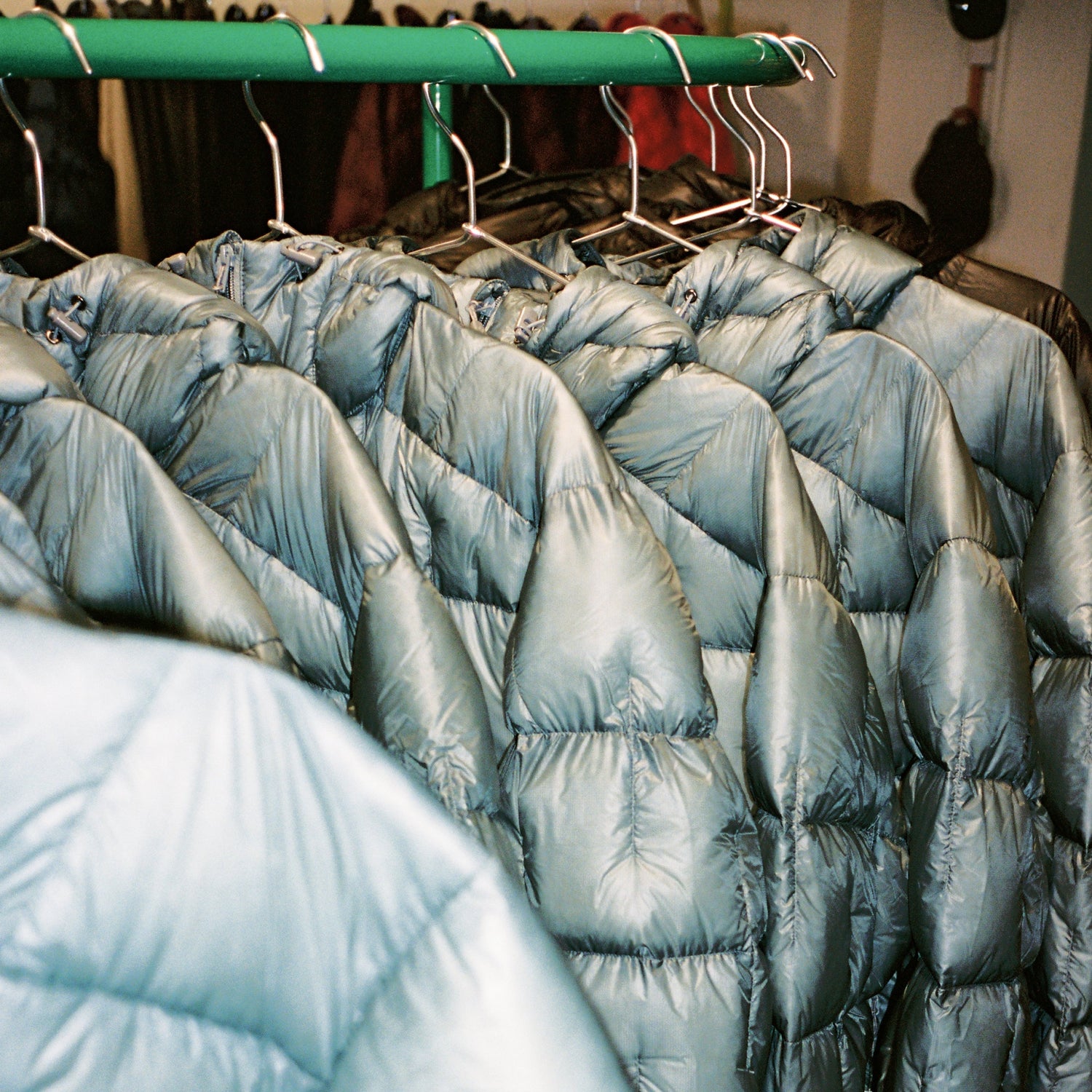 Choosing your Montbell Jacket displayed on hangers in a clothing store.
