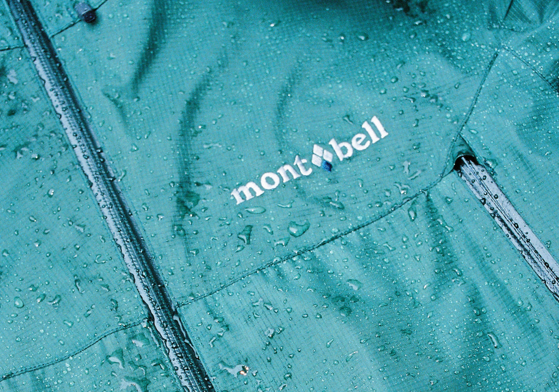 Close-up of the Montbell Rain Dancer jacket showing water droplets on its fabric.