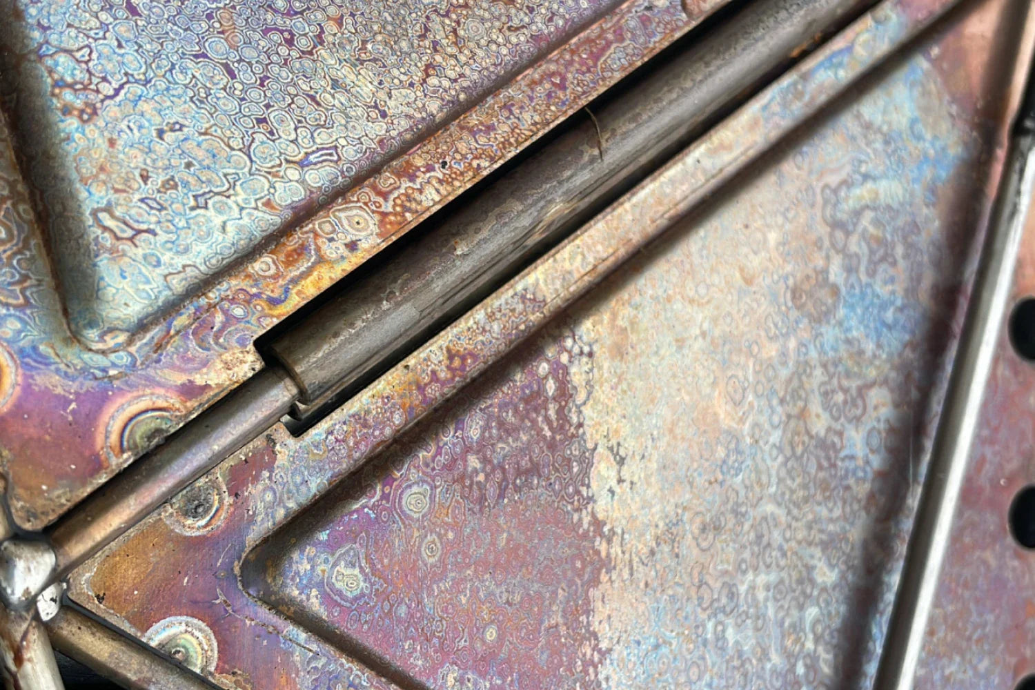 Close-up of colorful metallic surface of an outdoor heirloom by Snow Peak showcasing unique design details.