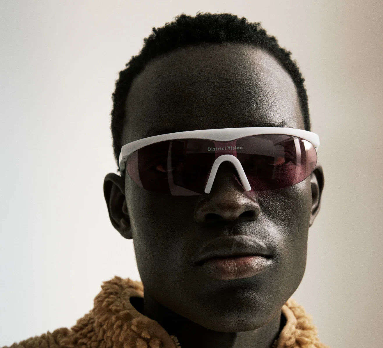 Person wearing stylish sunglasses promoting the message: Don't restrict your vision.