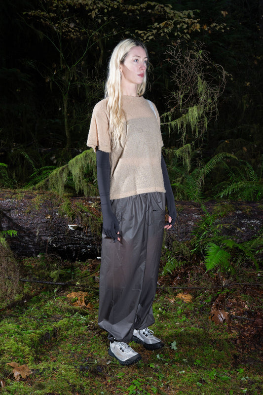Model wearing Shag Tee v2.0 in Cornstalk color, showcasing lightweight design in forest setting.