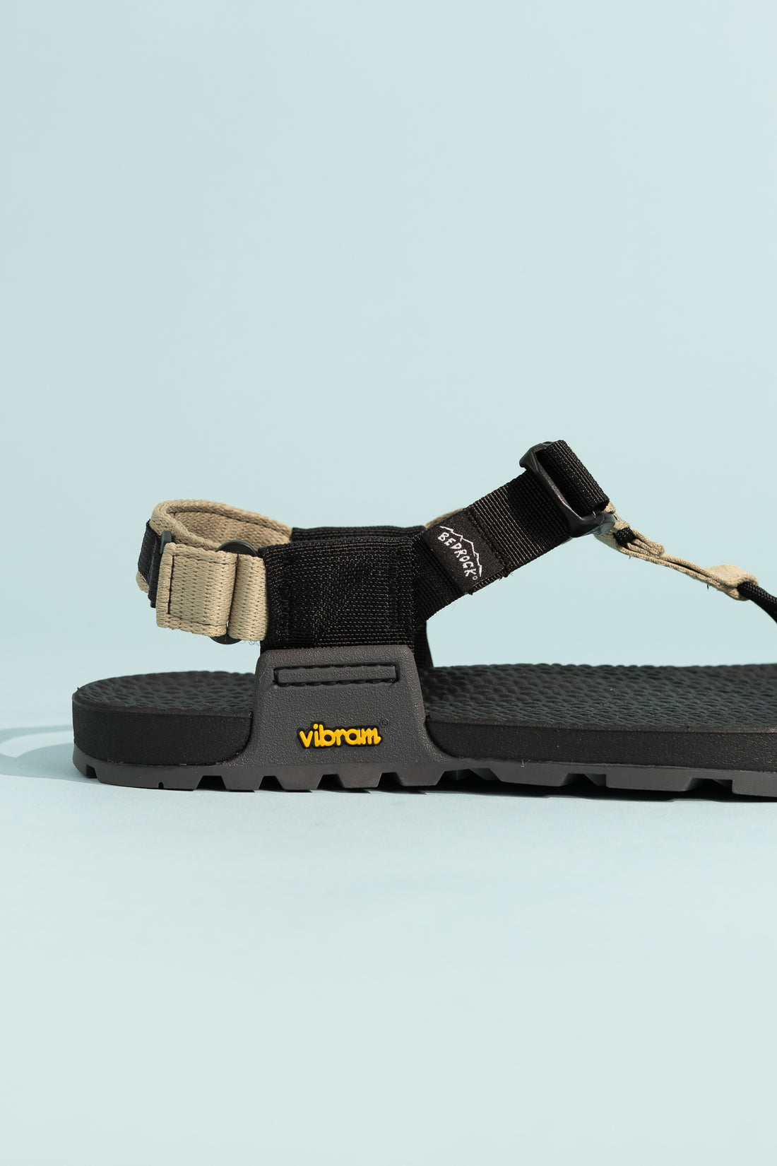 Pa'lante x Bedrock Sandals Cairn Evo 3D PRO Sandals in black with Vibram sole on light blue background.