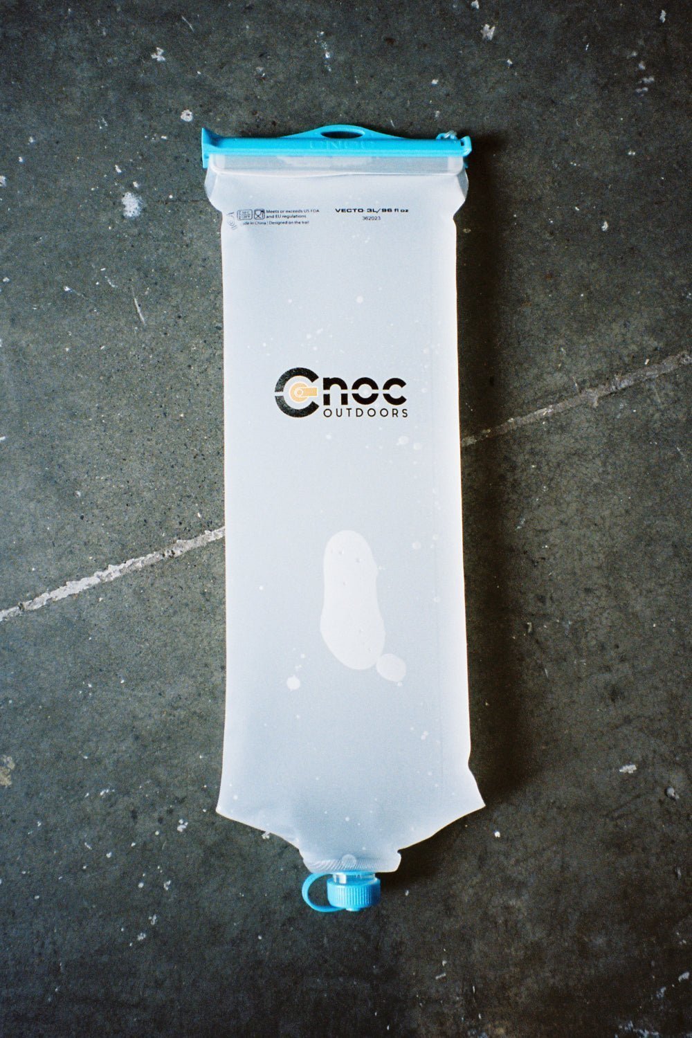 CNOC Vecto 3L Water Bladder 28mm Thread flat lay on concrete background