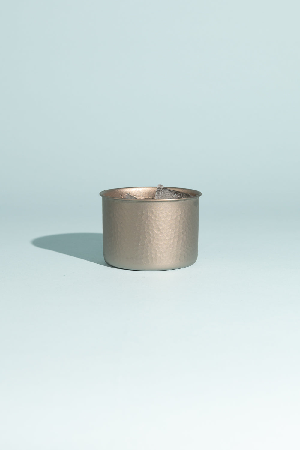 Evernew GubiGubi Titanium Cup with hammered finish on a light blue background, showcasing its unique design.