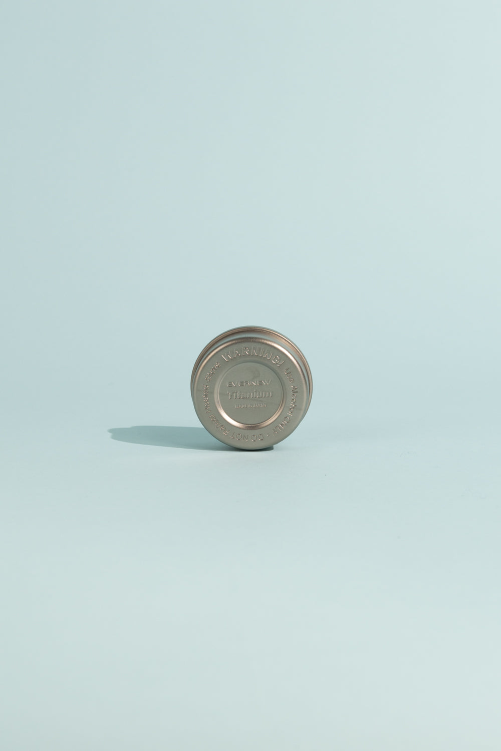 Evernew Titanium Alcohol Stove on a light background, highlighting its compact design and lightweight structure.
