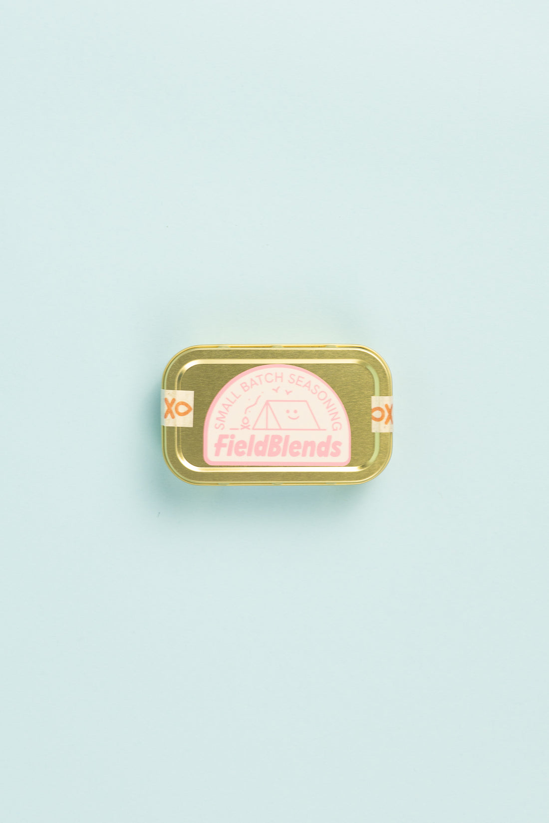Field Blends Pink Peppercorn, Sea Salt & Garlic camping tin on a light background.