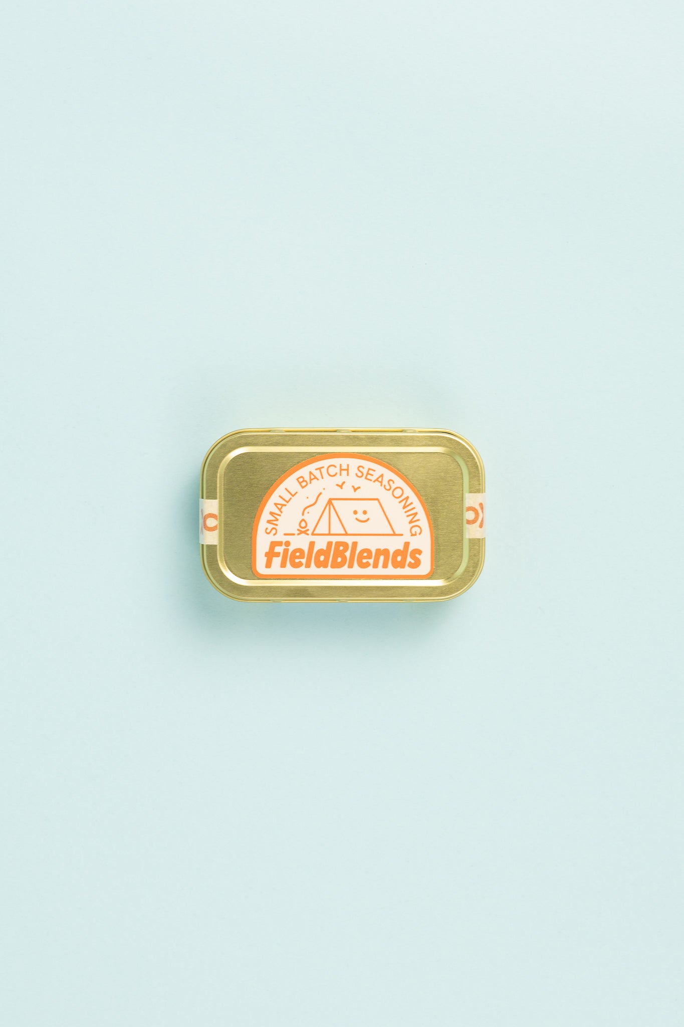 Field Blends Soy, Ginger & Sesame Camping Tin with small batch seasoning label on a light blue background.