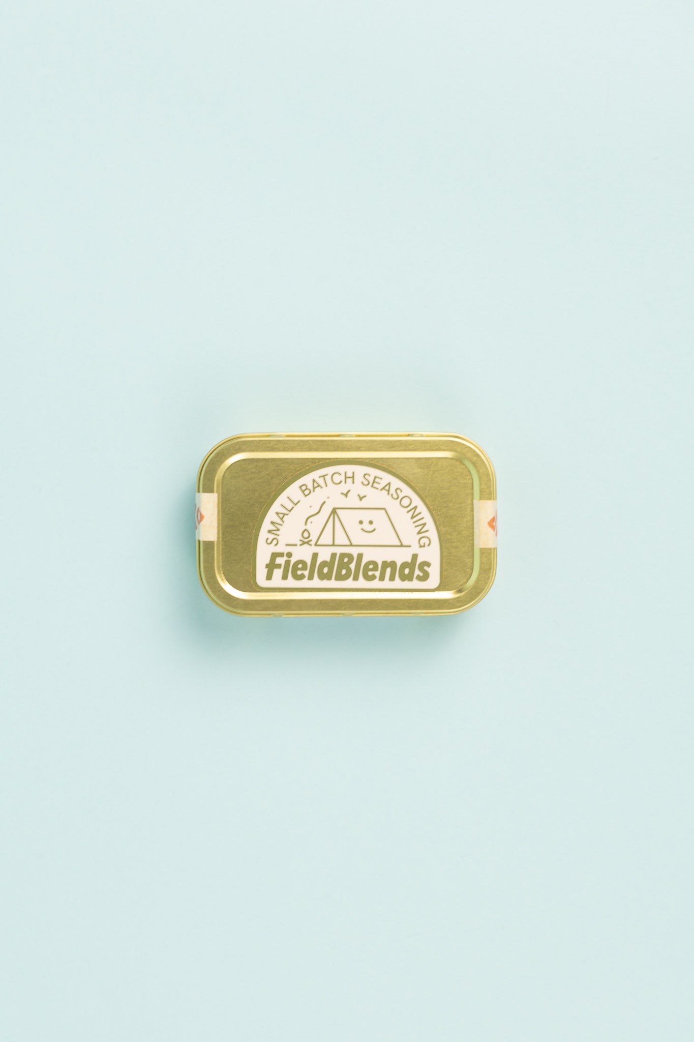 Field Blends Smokey Jalapeño & Peach - Camping Tin with small batch seasoning label on a light blue background.