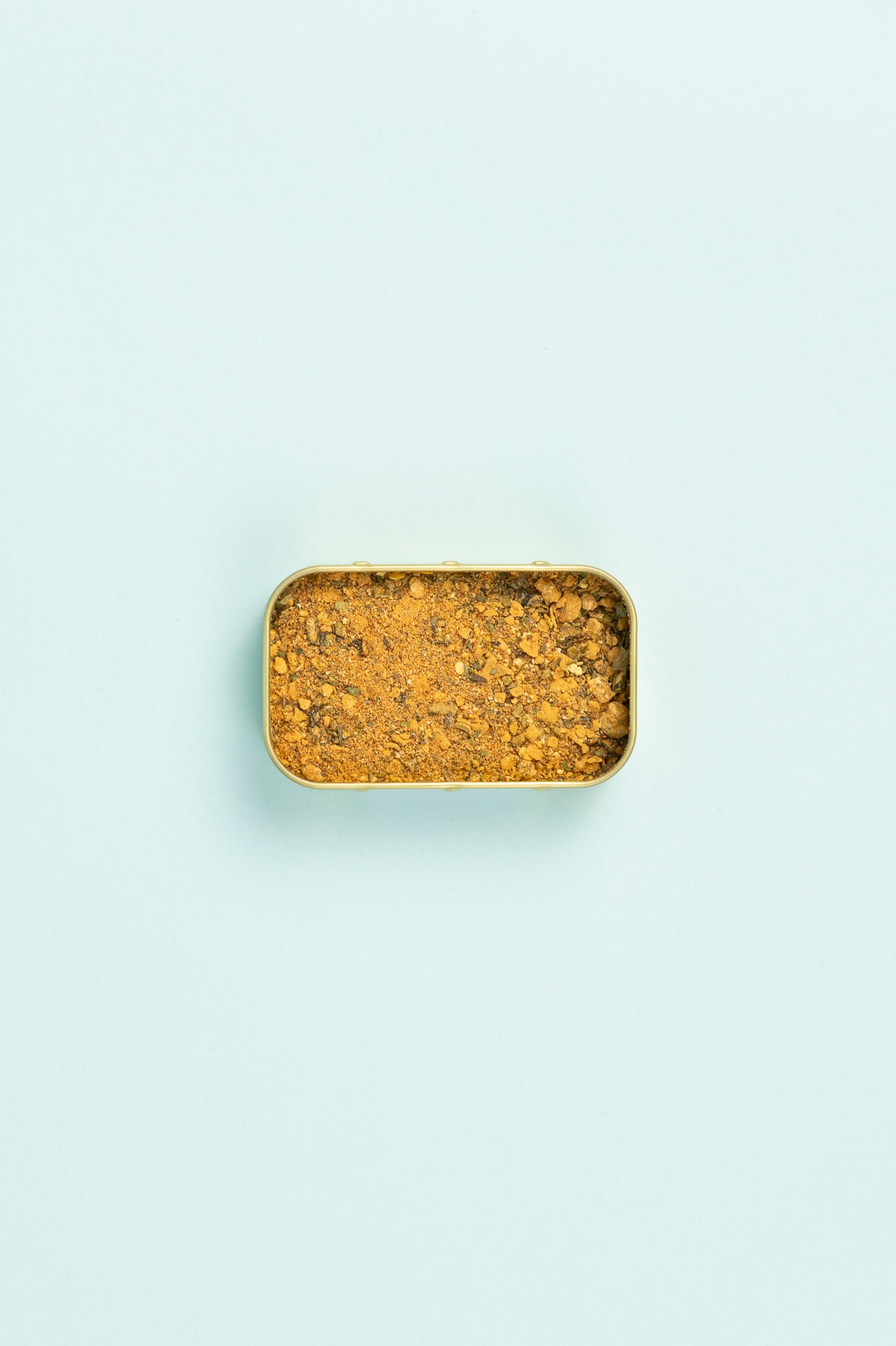 Field Blends Smokey Jalapeño & Peach spice mix in a small tin on a light blue background.