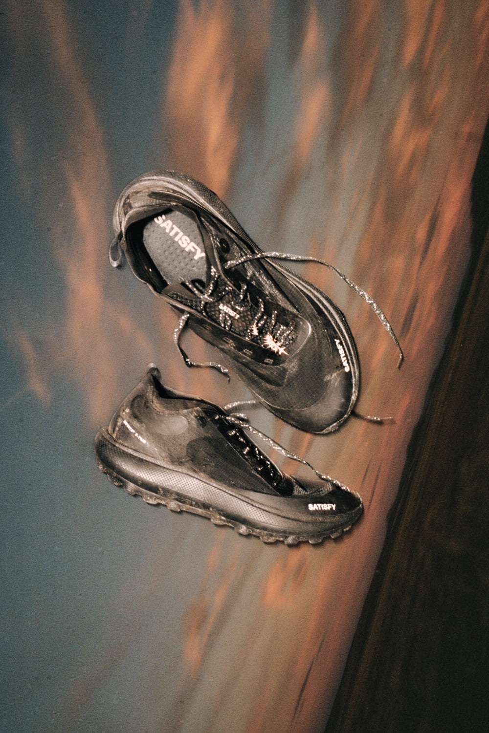 TheROCKER shoes in jet black, designed for ultra distance performance on various terrains.
