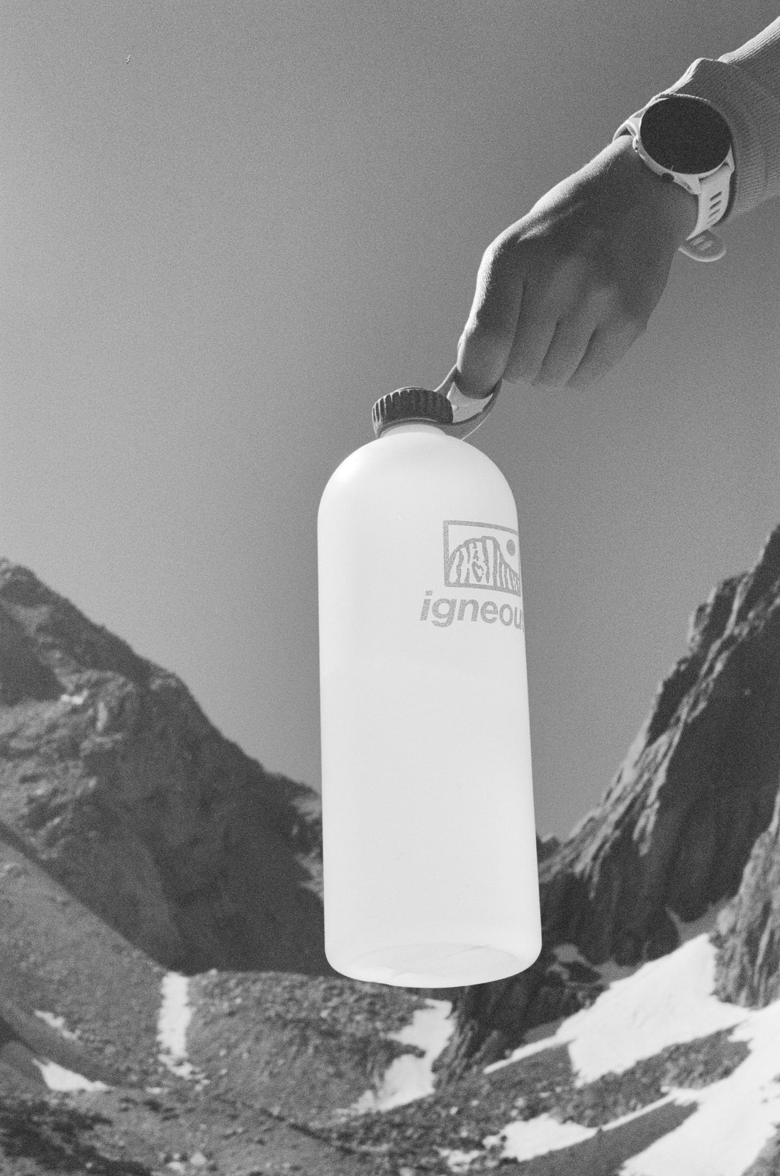 Igneous Gear NOBO Bottle held in hand against a mountainous backdrop, ideal for ultralight hiking.