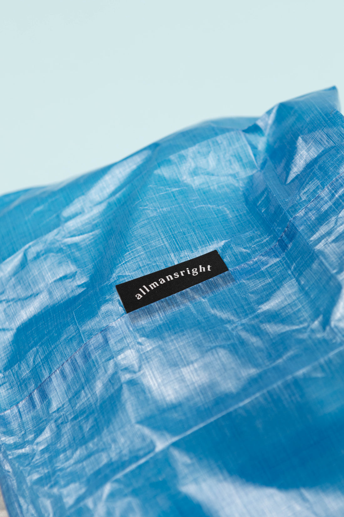 Allmansright Björn Food Bag Large - Blue close-up showing the ultralight Dyneema fabric and brand label.