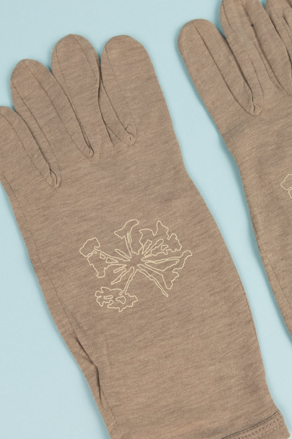 Desert Taupe Portal Drift Merino Gloves with flower design, ideal for chilly weather outdoor activities.