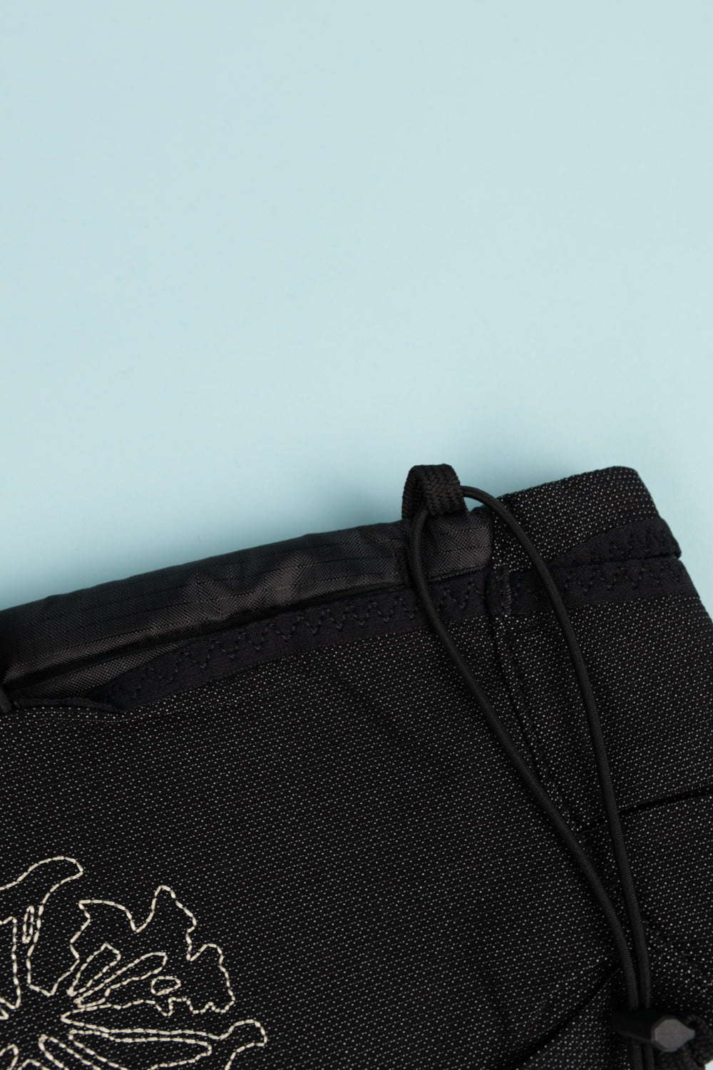 Close-up of the Portal Borders Cargo Belt featuring a stylish black fabric and adjustable drawstring detail.