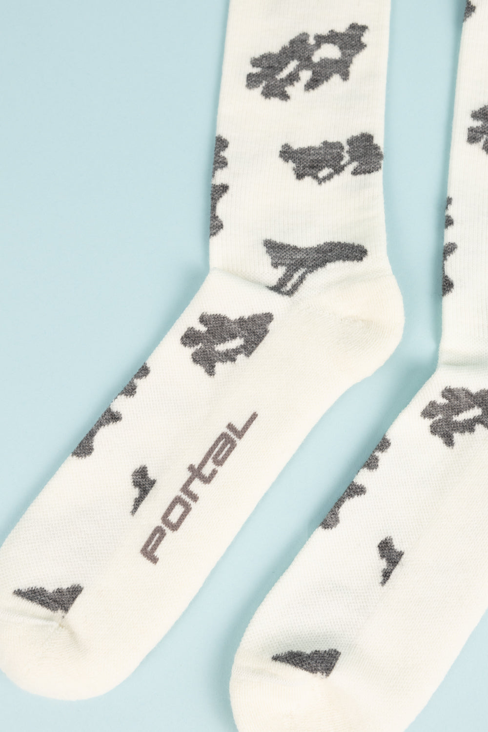 Portal Ritual Merino Socks in cream with dark graphic pattern, perfect for active wear and everyday use.