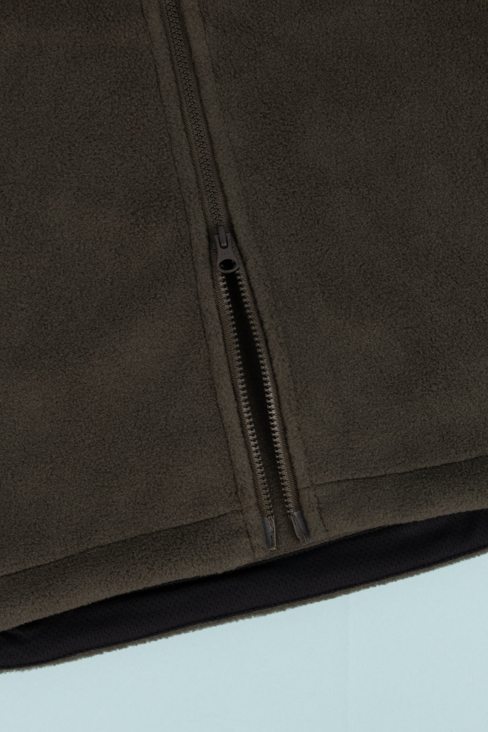 Close-up of the Portal Loam Fleece Jacket in Dark Olive, showcasing the zipper and soft fleece texture.
