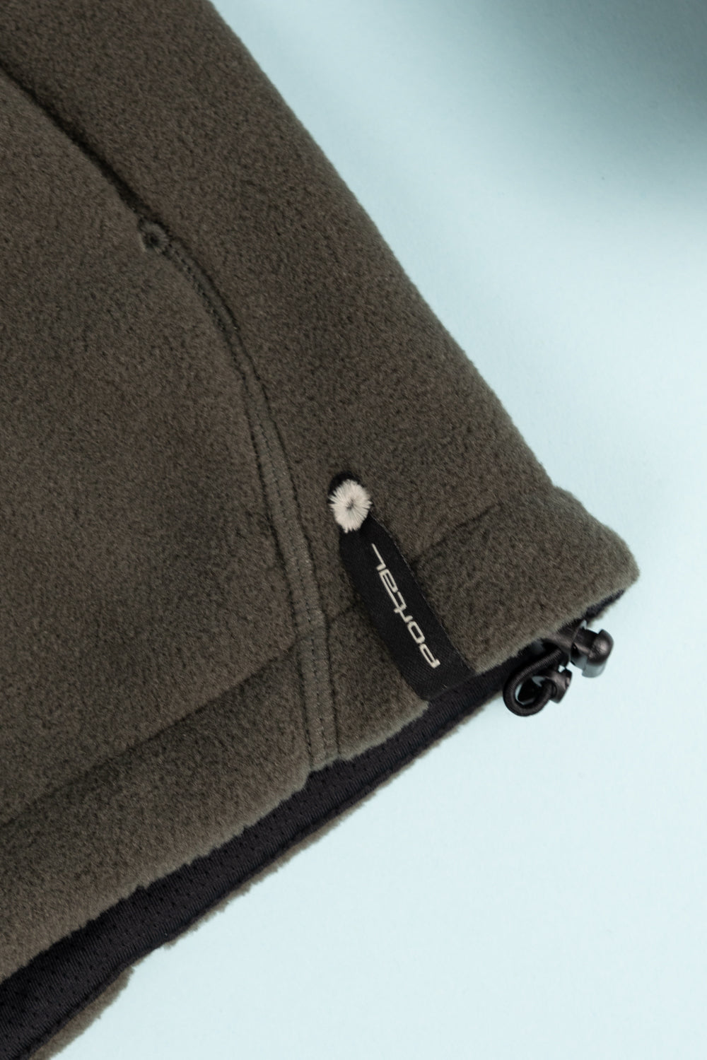 Close-up of the Portal Loam Fleece Jacket in Dark Olive showing Polartec® tag and fleece detail.