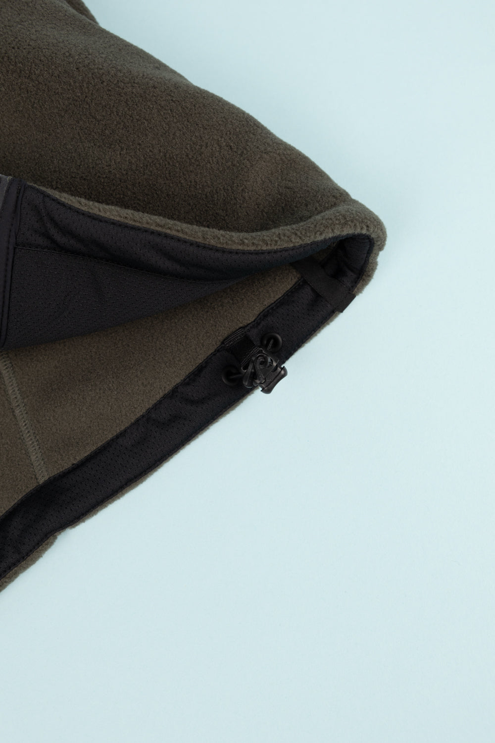 Close-up of Portal Loam Fleece Jacket in Dark Olive showing the fleece texture and adjustable hem feature.