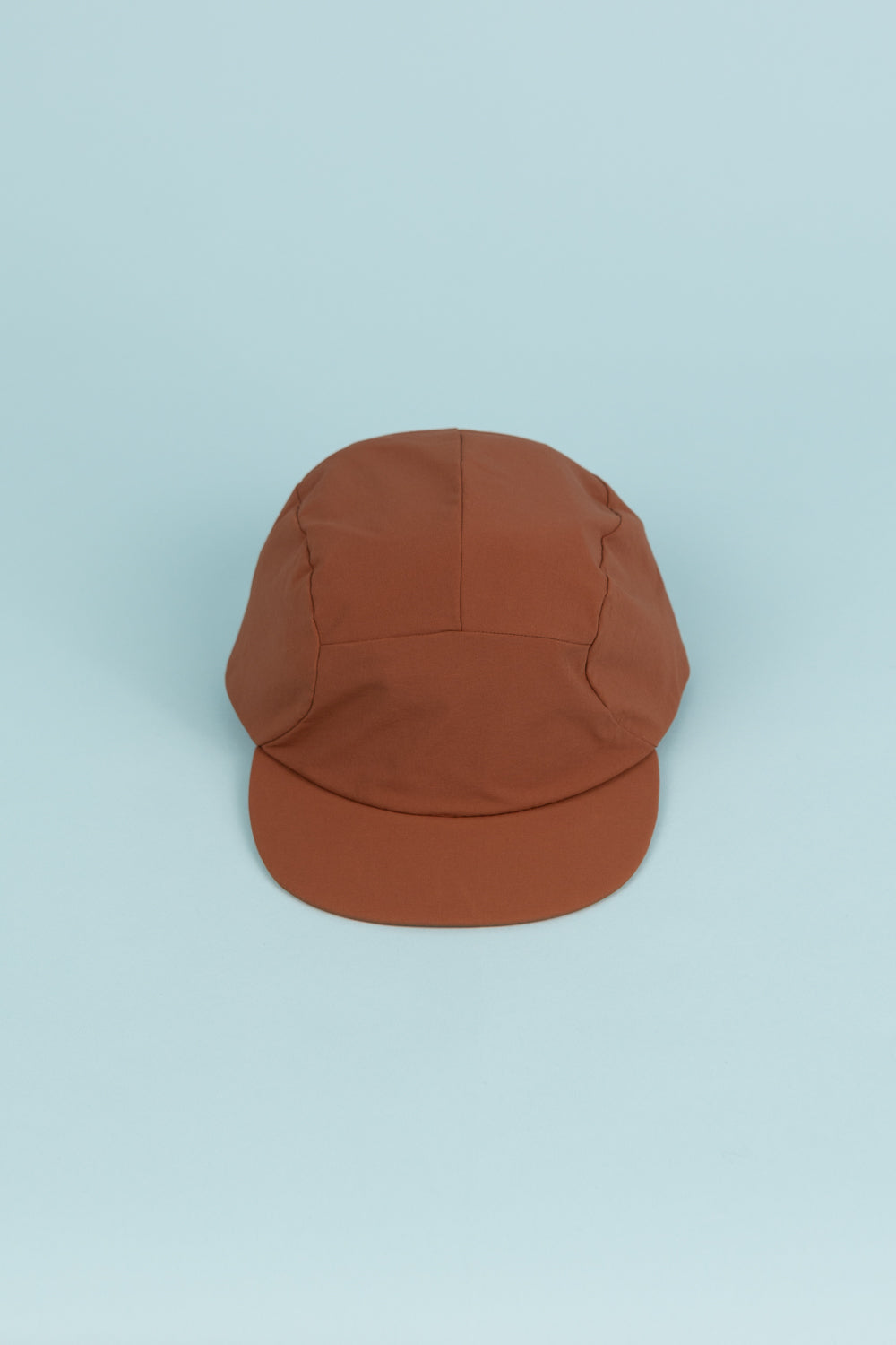 Portal Radius Cap in brown, featuring a lightweight design and secure fit, perfect for running and everyday wear.