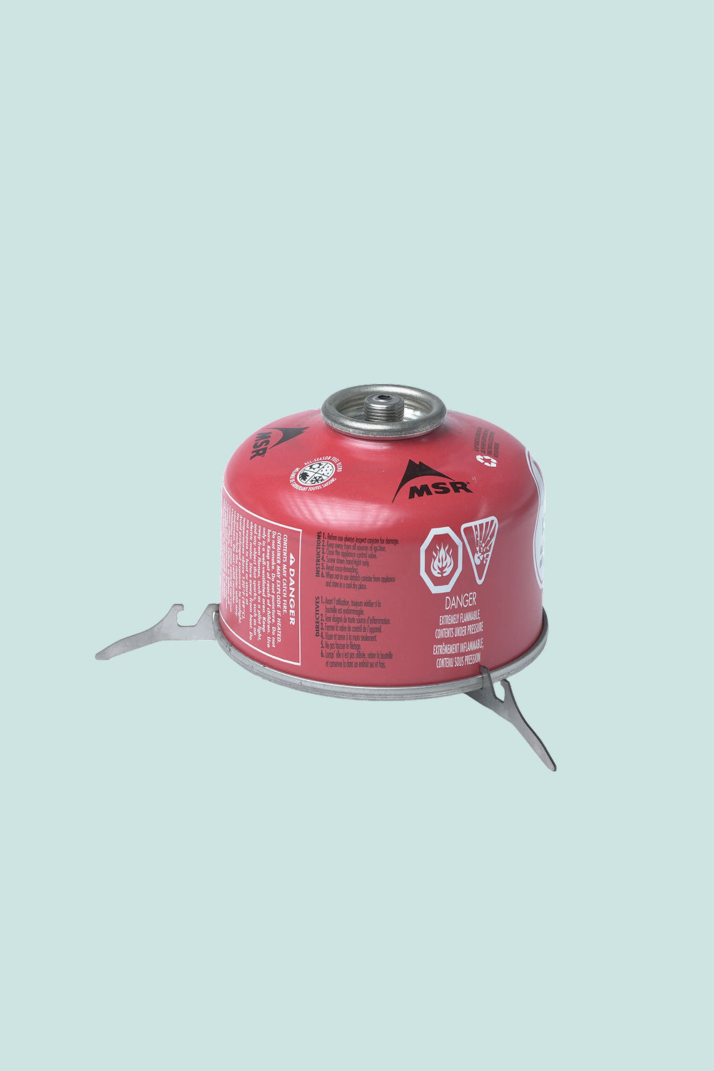 MSR fuel canister designed for camping stoves, featuring safety labels and foldable support legs.