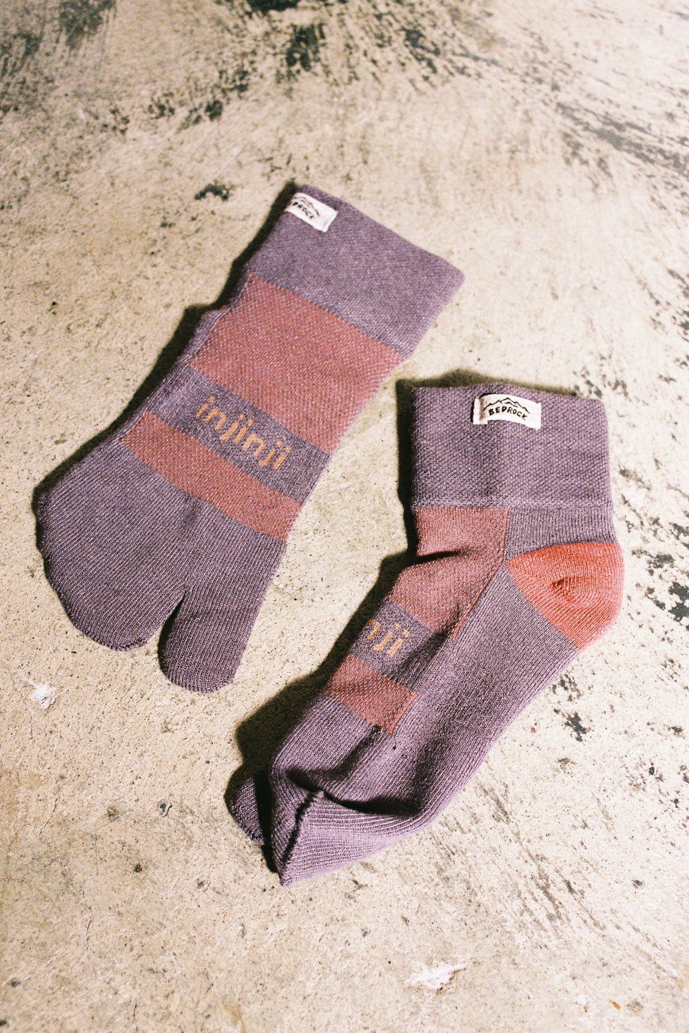 Bedrock Sandals x Injinji Mini-Crew Split Toe Socks in Dusty Plum color on a textured surface.